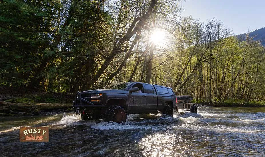 Lifted Truck driving in river bed