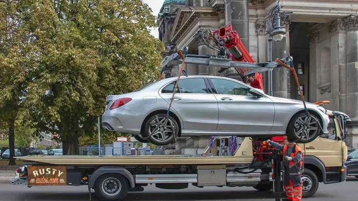 Rental car loading onto a tow truck